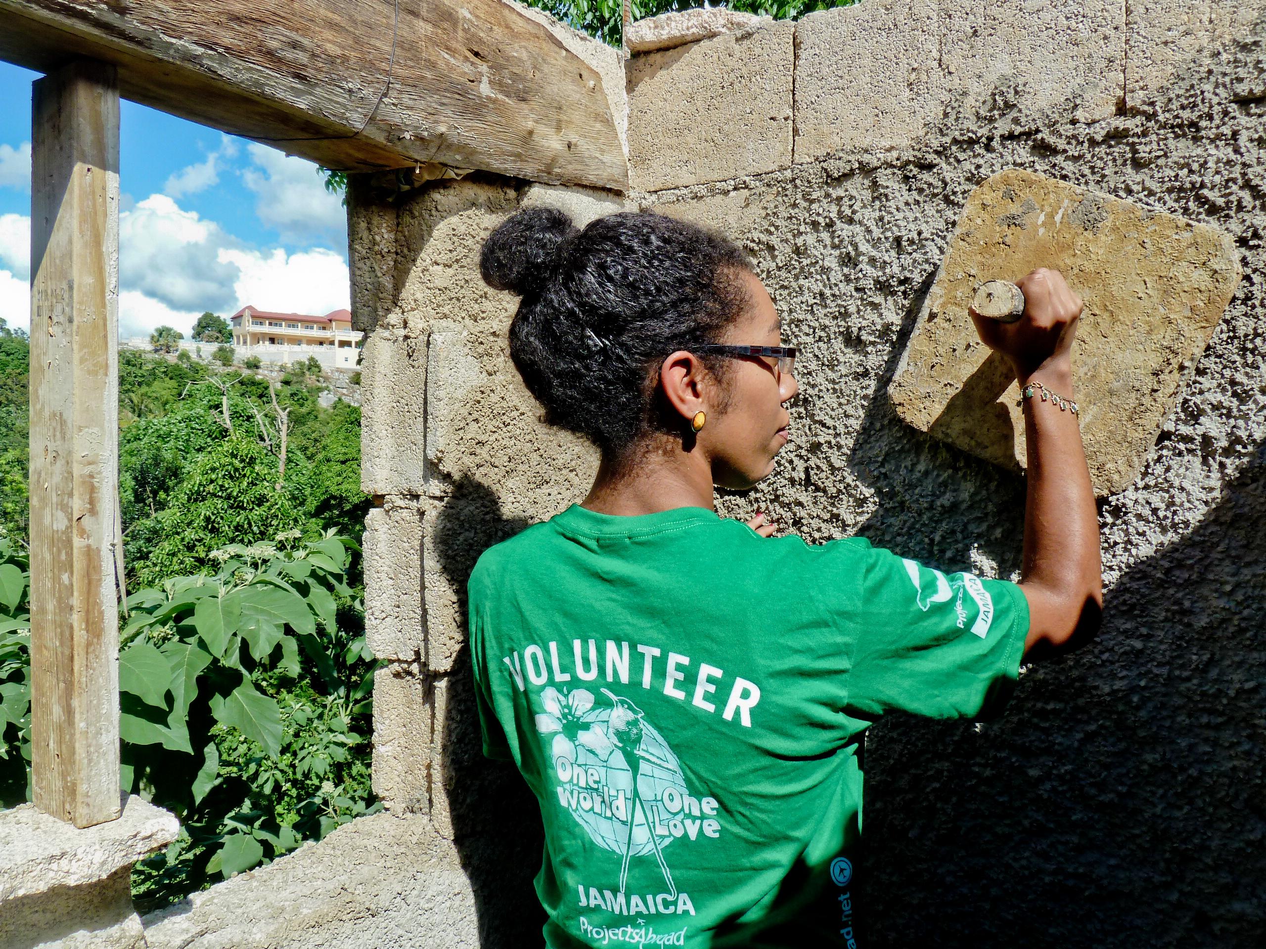 A female Projects Abroad volunteer helps plaster the walls during her building volunteer work in Jamaica. A female volunteer with Projects Abroad can be pictured helping with plastering as part of her building volunteer work in Jamaica.